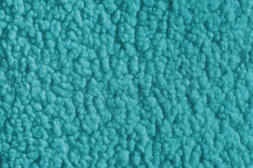 Vibrant turquose color fabric texture of soft faux fur cloth with fluffy surface, abstract background. Close up, macro of shaggy fabric texture, upholstery material, textile backdrop © katyamaximenko