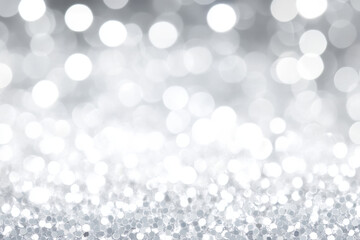 shimmering silver glitter bokeh fades into ethereal white glow evoking festive elegance for holiday wallpaper or banner with ample copy space