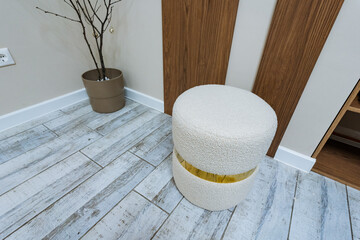 Chic Textured Pouf Amidst Rustic Flooring Creates Inviting Atmosphere, Modern Scandinavian Style...