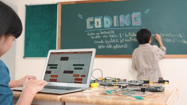 Girl writing engineering prompt by using AI software or programing system to generate AI on table with electronic main board at stem class while smart boy writing software development plan. Pedagogy.