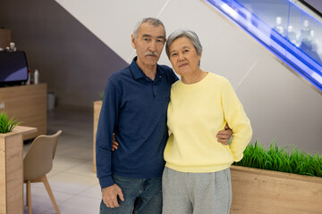 Portrait of an elderly Asian couple in a shopping mall. Happy elderly couple