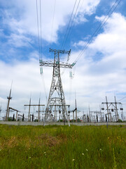 Power lines intertwined beneath ominous cloud formations, Modern electrical infrastructure spread...