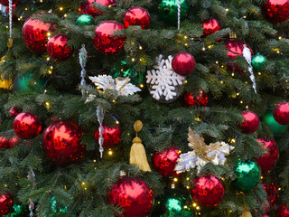 New Year's Eve decoration of street. Christmas trees with balls on branches.