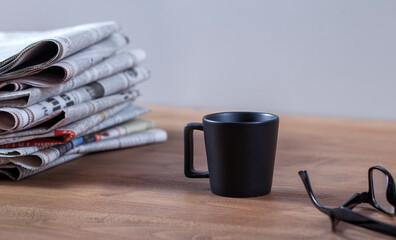 newspaper and coffee on office table
