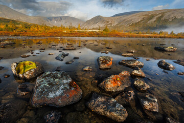 Misty Mountain Lake Landscape With Mossy Rocks, Autumn Colors, And Reflections