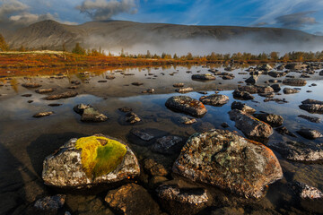 Misty Mountain Lake Landscape With Mossy Rocks, Autumn Colors, And Reflections