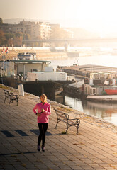 Healthy happy runner city running at sunset.
