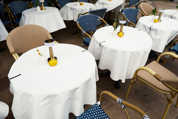 Outdoor Caf? Tables with White Tablecloths and Decor