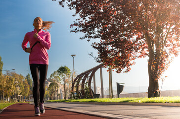 Healthy happy runner city running at sunset.