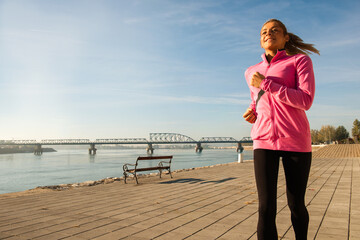 Healthy happy runner city running at sunset.