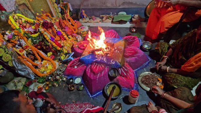 Religious fire ritual in progress captures the essence of Hindu worship, with mantras, offerings, and ceremonial items arranged around the sacred flame.