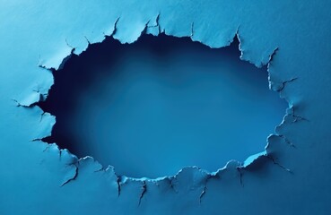 Obraz premium Torn blue paper forms abstract shape with frayed edges revealing dark void within. Material ripped, creating textured background for copy space. Design element with broken texture.