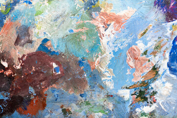 Colorful Abstract painting painted with palette knife and brush in oil paint in blue, violet, brown, pink shades. Closeup Background.
