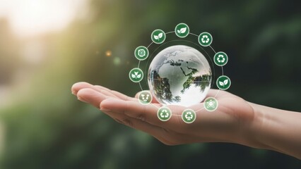 Hand holding a glass globe with green icons around it, symbolizing ecofriendly and sustainable practices