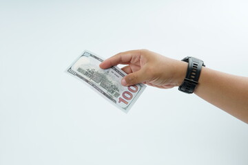 Hand holding US dollar banknote on white background representing payment, cash transaction, financial exchange, income, salary, and money concept with copy space.