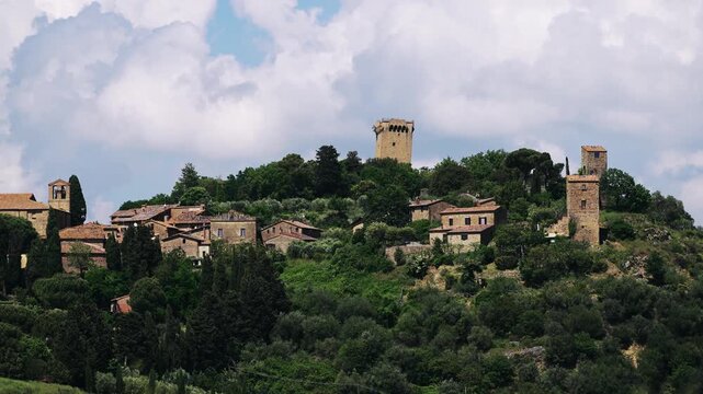 Panoramic aerial view of Monticchiello Village surrounded by lush greenery in Tuscany, Italy