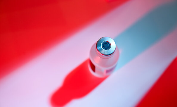 Close up of  Vial of Medicine with Strong Red and Blue Shadows