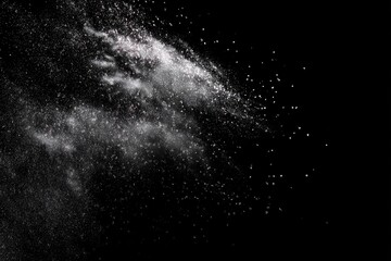 Abstract image of white particles scattered against a stark black backdrop, creating a dynamic effect