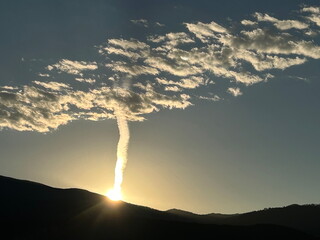 Contrail and clouds at dawn over Santa Fe, NM