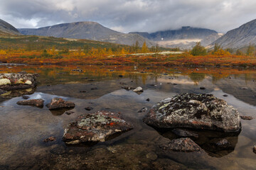 Autumn Mountain Lake Landscape With Reflections, Large Rocks, and Calm Water in Remote Valley