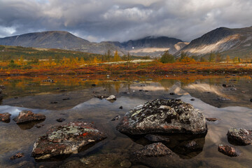 Autumn Mountain Lake Landscape With Reflections, Large Rocks, and Calm Water in Remote Valley