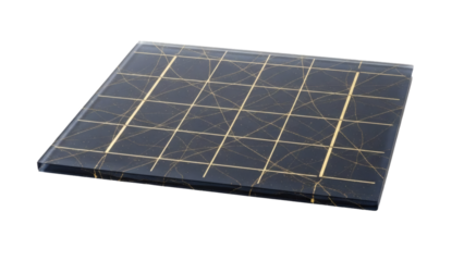 A dark, rectangular, glass-like panel displays an intricate, abstract pattern of thin, intersecting gold lines.