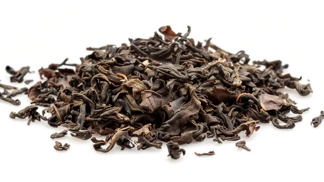 Video A pile of dried black tea leaves on a white surface