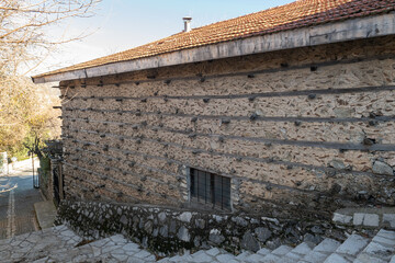 The exterior of a historic buttoned house built with traditional stone and wood craftsmanship.