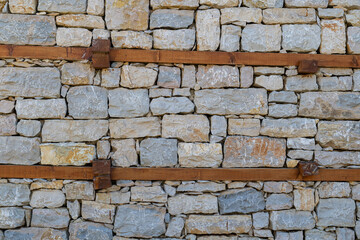Wall texture showing stone and wood frame details from traditional buttoned house architecture.