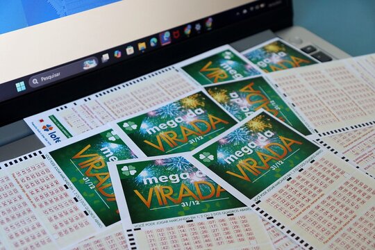 Salvador, Brazil - December 24, 2025: Mega da Virada lottery tickets. Brazilian New Year's Eve 1 Billion Reais jackpot betting slips. Loterias Caixa Mega da Virada. Mega Sena. 
