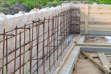 Construction of a new concrete foundation for a residential building at a construction site.