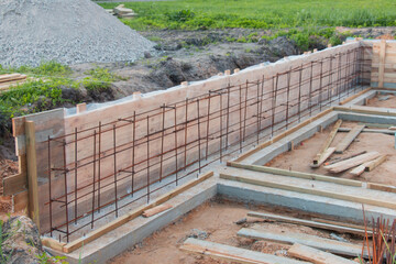 Construction of a new concrete foundation for a residential building at a construction site.