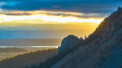 Aerial Mountain Sunrise Over Forested Slopes and Rocky Peaks California