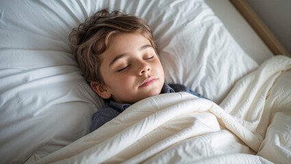 Peaceful young boy sleeping soundly in a comfortable bed with soft white bedding