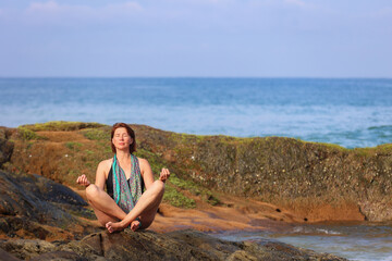 Serene Woman Meditating Outdoors by the Blue Ocean