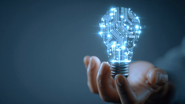 デジタル回路の模様が光る電球を持つ手
