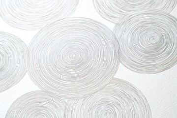 Artistic image of grey swirling circles overlapping against a textured white background