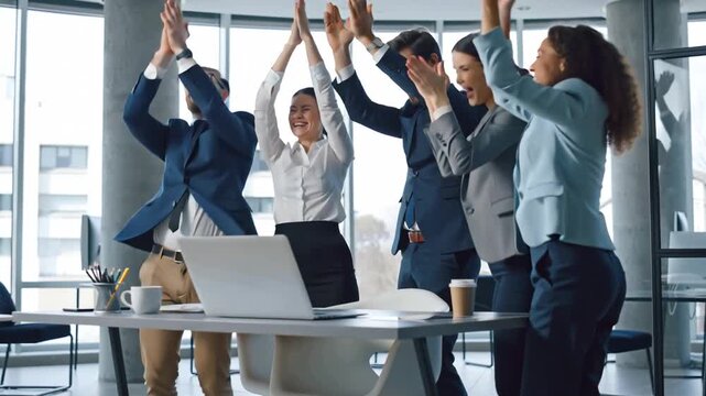 A team of happy business people in the office rejoice, clap their hands, victory, joy