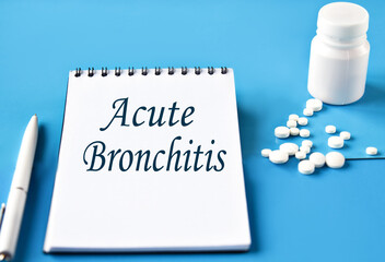 ACUTE BRONCHITIS - words in white notebook on blue background with pills and pen
