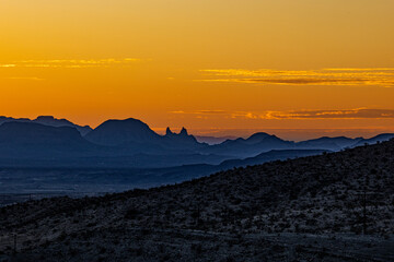 A golden sunset silhouettes the mountains of Big Bend.
