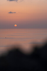 sunset over calm sea with orange sky