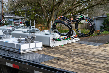 Wireless communications cell site upgrade to 5G technology, panel antennas on flatbed truck in residential neighborhood

