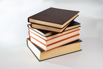 Stack of many different books isolated on white. Old books vintage top each over on white background. Collection aged book concept.