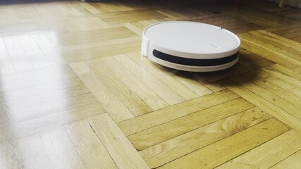 Italy, Borgo San Dalmazzo, December 26, 2025.
Robot Vacuum Cleaner Cleaning Parquet Floor Indoors.
 Author: Djundiet A.
