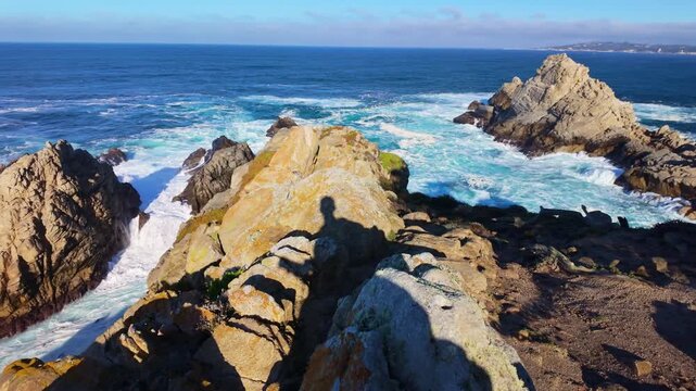 Pacific Ocean waves strike rugged coastal cliffs at Point Lobos State Natural Reserve in California