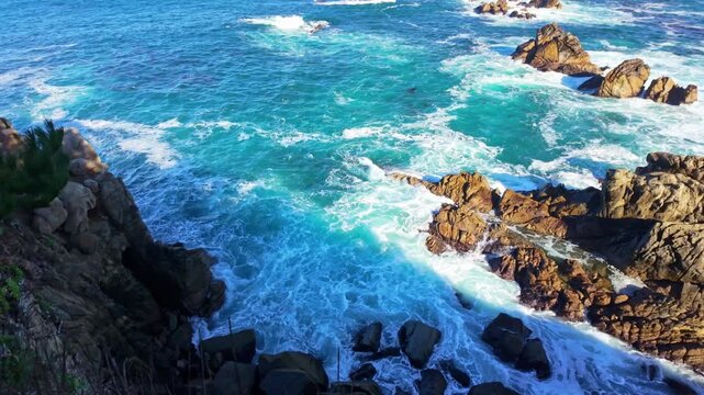 Pacific Ocean waves strike rugged coastal cliffs at Point Lobos State Natural Reserve in California