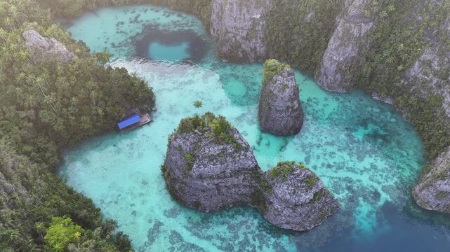 Rock islands, composed of ancient, uplifted reefs, rise from the seascape in Misool, Indonesia. This region harbors spectacular marine biodiversity and is a popular diving destination.