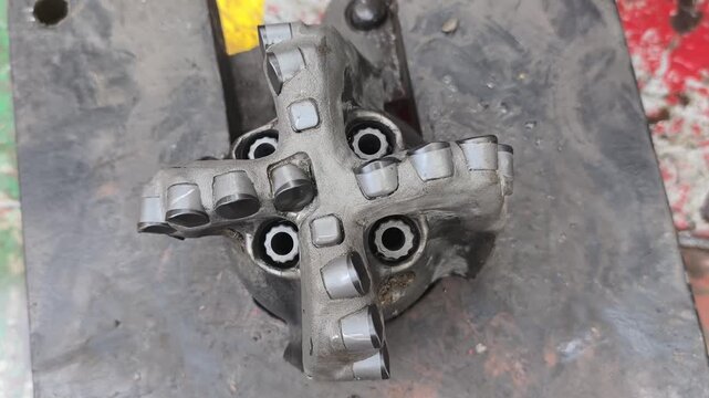 Polycrystalline Diamond Compact (PDC) drilling bit on the rig floor used for drill oil and gas well for petroleum exploration and production.

