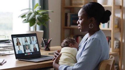 Empowered Black Mother Juggling Work and Baby during Video Call, Highlighting International Women's Day Gender Equality and Modern Parenthood
