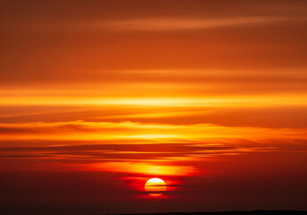 Vibrant sunset ablaze with fiery orange hues, a celestial spectacle painting the sky with warmth and tranquility